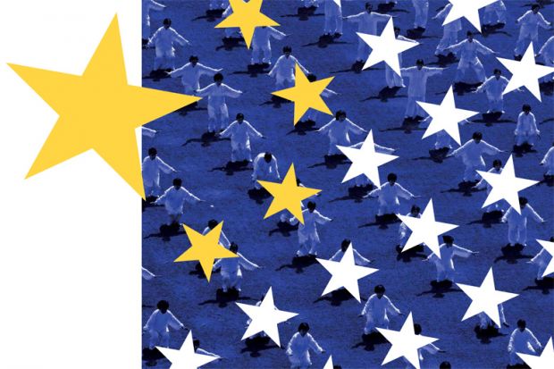 Crowd performing tai chi with stars of Chinese flag in foreground Crowd performing tai chi with stars of Chinese flag in foreground