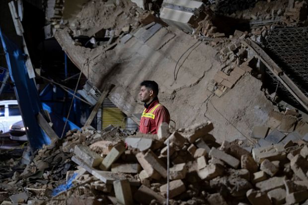 An Iranian firefighter in the ruins of a collapsed building in Tehran on March 11, 2025