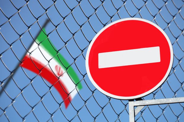 A no entry sign next to an Iranian flag A no entry sign next to an Iranian flag symbolising restricted academic freedom