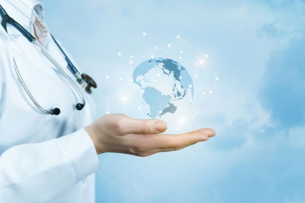 Doctor holds globe, illustrating THE University Impact Forum: Improving Health Outcomes, Transforming Lives