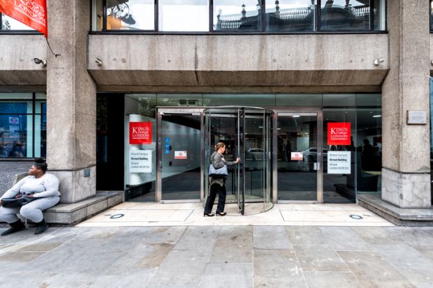 King's College red sign and entrance on Strand Campus Macadam Building with people entering