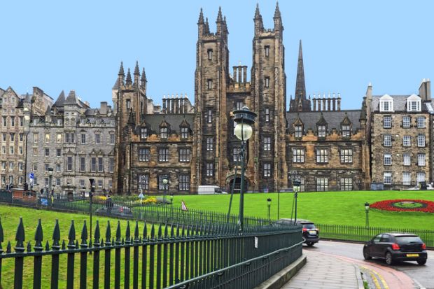 The gothic spires of the University of Edinburgh on a hillside leading to the Old Town district.