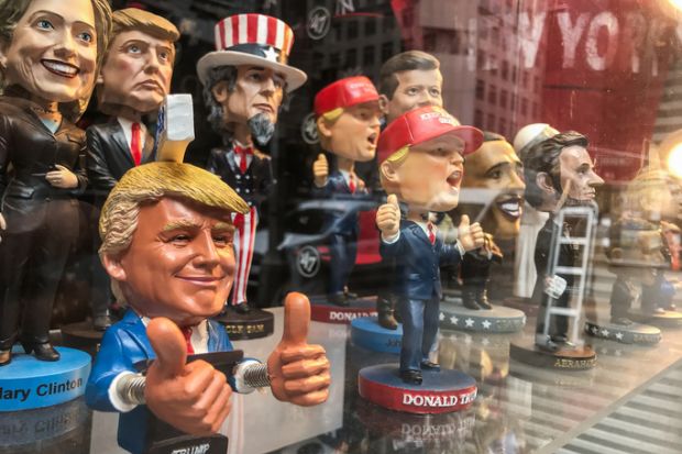 Bobble head dolls of various political figures are seen on a gift shop's window display. Bobble head dolls of various political figures are seen on a gift shop's window display.