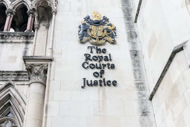 rest on the wall of Royal Courts of Justice on the Strand in central London