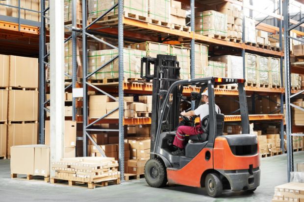 Warehouse worker in uniform loading boxes by forklift warehouse worker in uniform loading boxes by forklift to show lift and shift in transnational education