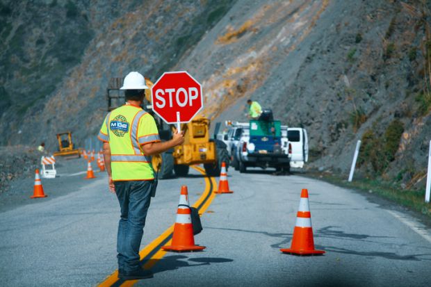 Road workers repairing the Highway #1 at the US West Coast 