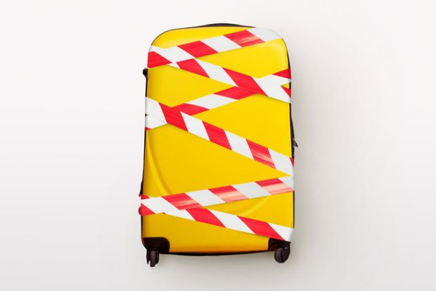 A yellow suitcase bound up with tape A yellow suitcase bound up with tape