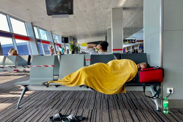 Kiev Ukraine-July 2021: A tired man sleeps on a bench at the airport while waiting for his transit flight. Kiev Ukraine-July 2021: A tired man sleeps on a bench at the airport while waiting for his transit flight.
