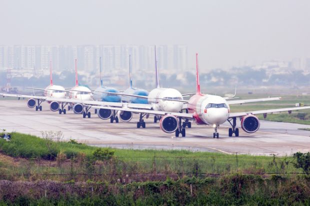 Aeroplanes queue for takeoff on runway in Ho Chi Minh City