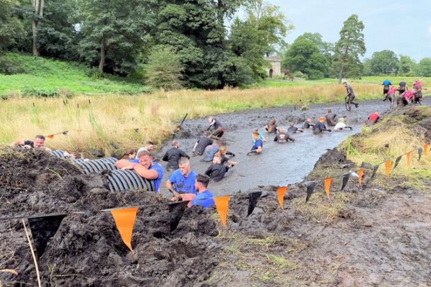 Participants in a 'Tough Mudder' event Participants in a 'Tough Mudder' event