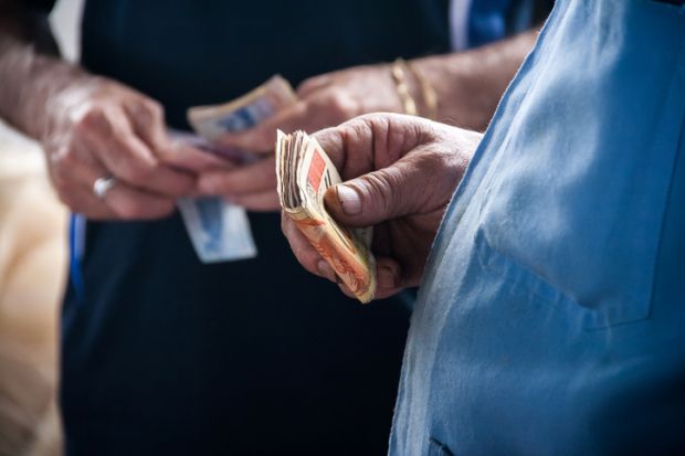 Hand of a person holding money banknotes