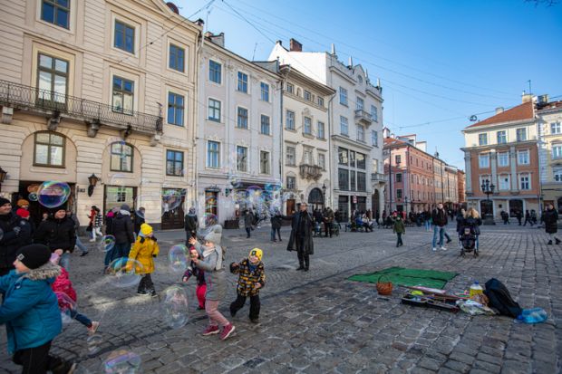 Children playing on a cobblestone street in Ukraine's Lviv