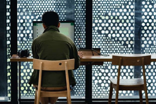 A man uses whatsapp on a computer belonging to the jakarta library.