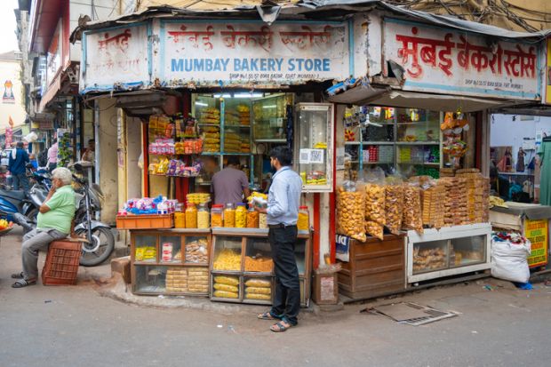 Indian man at bakery in the street. Indian man at bakery in the street.