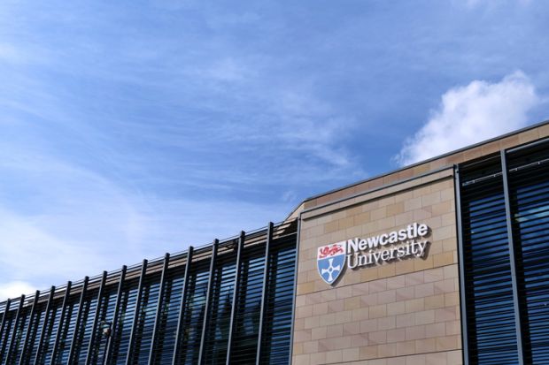 Newcastle University Kings Gate building, with university logo and lettering against sandstone wall Newcastle University Kings Gate building, with university logo and lettering against sandstone wall