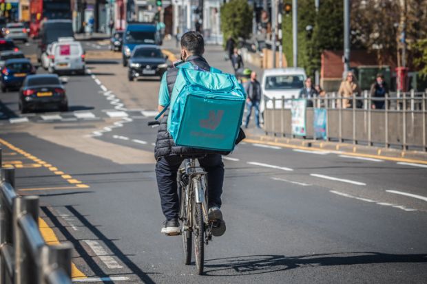 A Deliveroo cycle delivery worker on London street.
