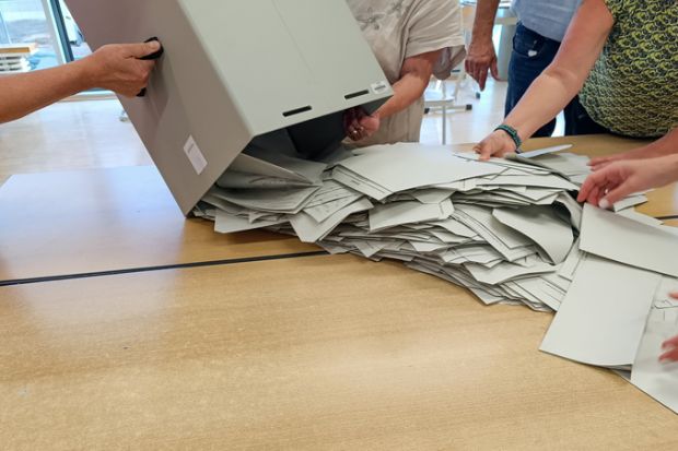 ballot papers are spread out from the ballot box for counting