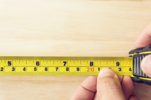 Hand Holding A Tape Measure