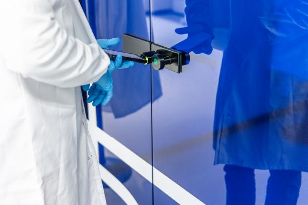 Scientist using phone to open laboratory door