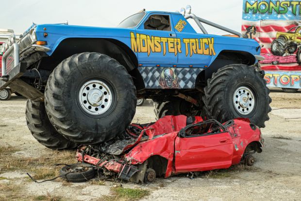 Huge Monster Truck climbs, crushes and completely destroys a demo car.