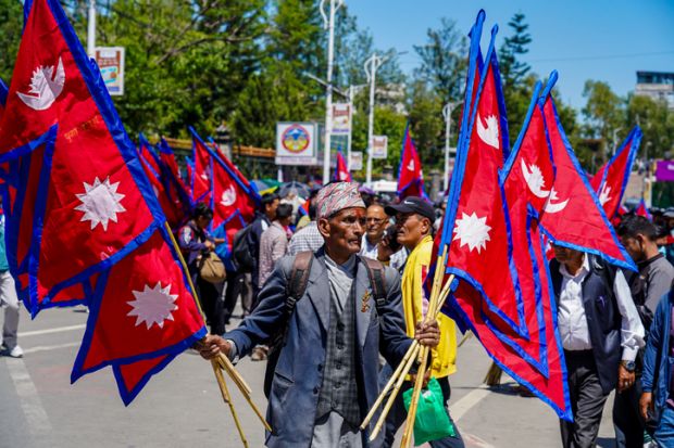 Pro-monarchy demonstrators waving national flags during a rally in Kathmandu, Nepal, in May 2025