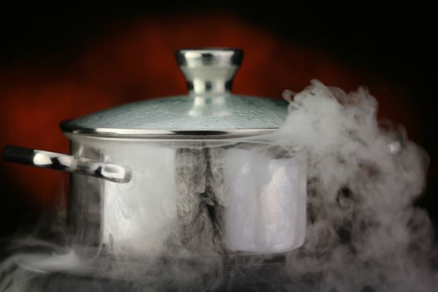 Steam escapes from boiling pot