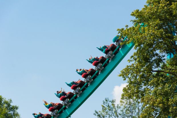 A roller coaster ascends Visitors enjoying a roller coaster ride as it ascends