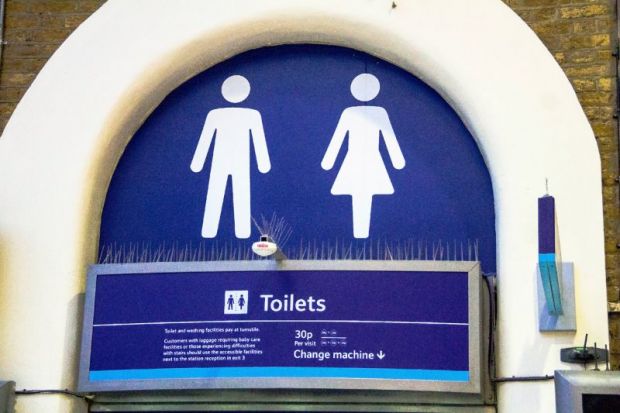 White lady and man toilet sign on blue background at Charing Cross railway station.