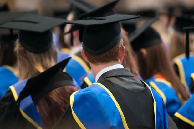 Students sit in a row at their university graduation ceremony. Students sit in a row at their university graduation ceremony.