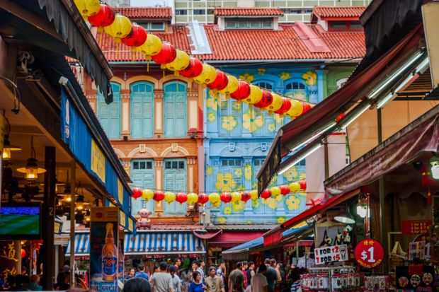 Tourists walking along Singapore china town market
