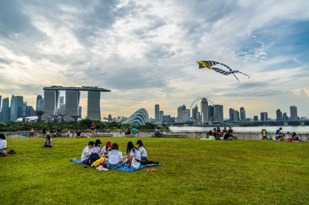 Singapore - 1 October 2016: People enjoying their weekend with different activities at the rooftop of Marina barrage.