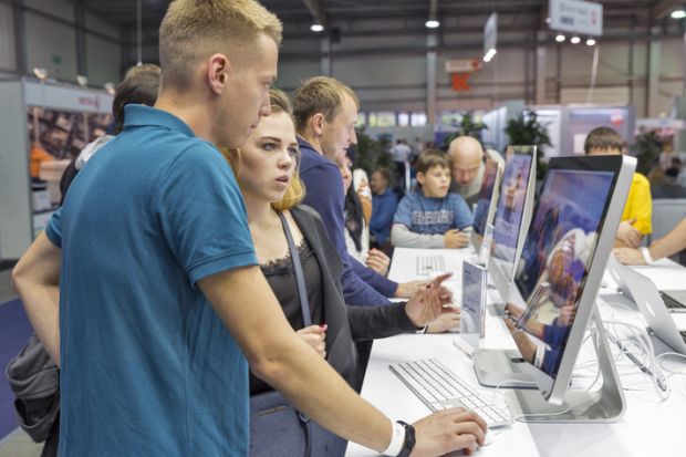 Unrecognized people visit Apple, American multinational technology company booth during CEE 2016. Unrecognized people visit Apple, American multinational technology company booth during CEE 2016.