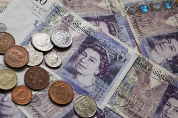 Twenty Pound Notes and coins of pounds sterling the currency of the UK. Twenty Pound Notes and coins of pounds sterling the currency of the UK.