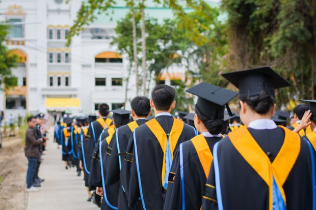 Back of graduates during commencement at university.