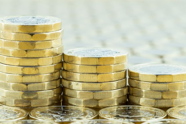 British money, three pound coins descending stacks. British money, three pound coins descending stacks.