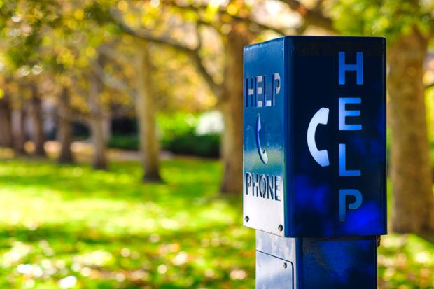 A blue emergency phone box labled "HELP" at a university campus in Melbourne, Austalia