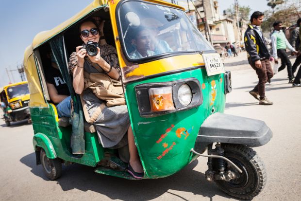 Smiling girl with camera on a tuk-tuk. The smiling girl with camera on a tuk-tuk.