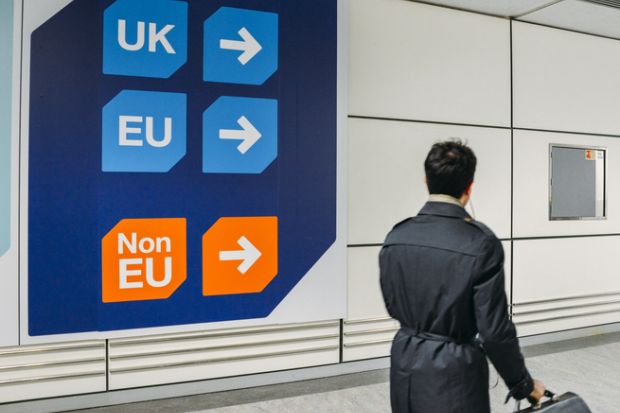 Passenger walks past sign prior to immigration control pass a sign pointing towards queues for UK, EU and Non-EU passport holders. Passenger walks past sign prior to immigration control pass a sign pointing towards queues for UK, EU and Non-EU passport holders.