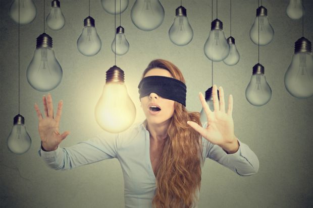 Blindfolded woman can’t see light bulb in front of her oblivious unaware blind bright ideas light bulbs blindfold