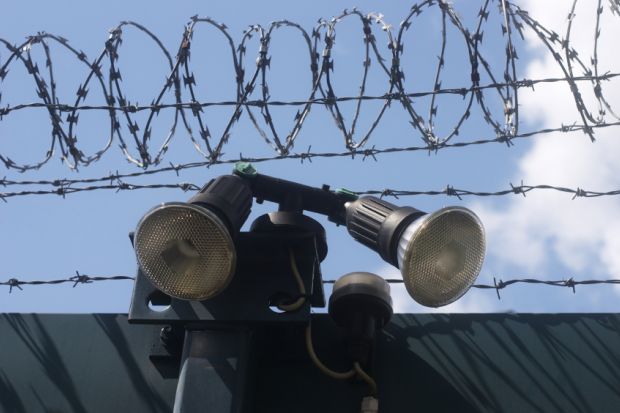 Razor wire and searchlights
