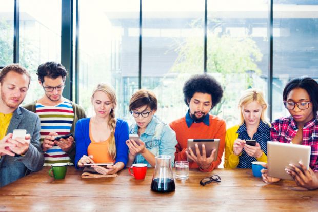 Young people using smartphones and tablets Young people using smartphones and tablets