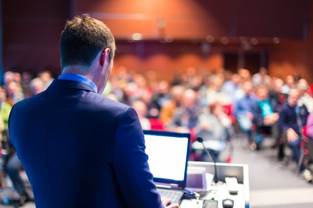 Speaker giving presentation at conference