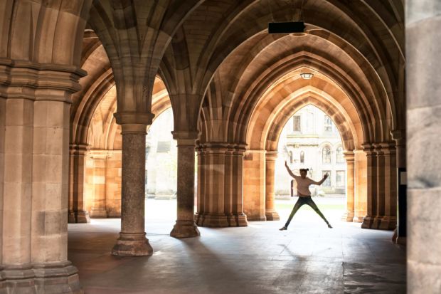 Girl jumping in cloisters of University of Glasgow Girl jumping in cloisters of University of Glasgow
