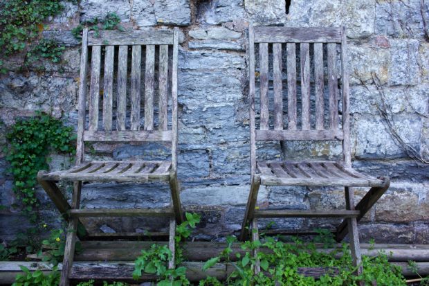 Pair of empty, aged wooden chairs Pair of empty, aged wooden chairs