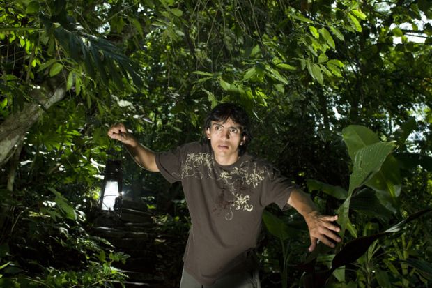 A man looking fearful in the jungle, illustrating visceral fear