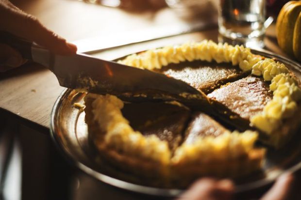 Knife cutting pie into slices