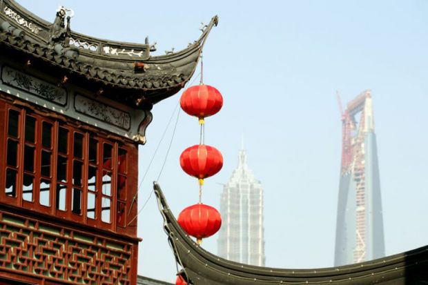 Lanterns hanging from temple roof, Shanghai Red lanterns hanging from a temple roof in Shanghai