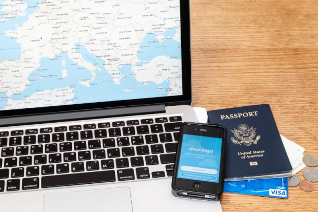 Preparing to travel Laptop, passport, phone and credit card for travelling