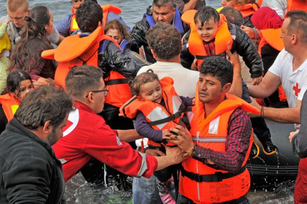 Volunteer rescuers helping refugees on Lesvos in Greece Volunteer rescuers helping refugees on Lesvos in Greece