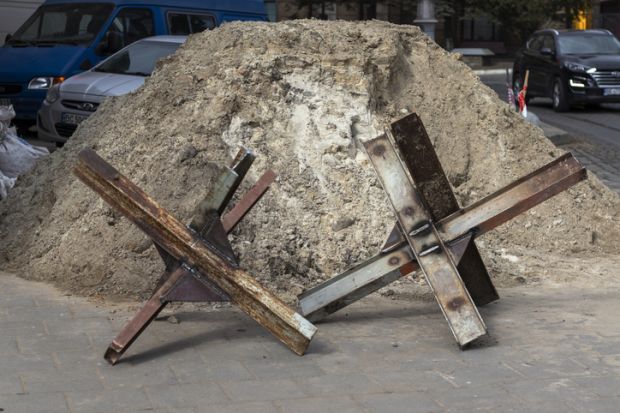 Lviv, Ukraine - March 10, 2022. Daily life during the war. Czech hedgehogs (anti-tank obstacles) on the city street.